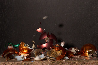 Assortment of shattered drinking glasses in various colors and shapes