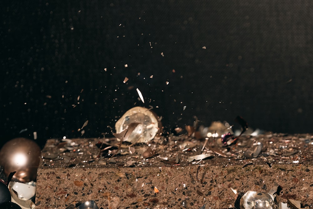 a pile of debris sitting on top of a dirt field