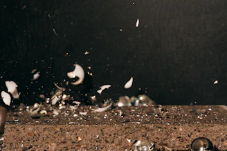 Broken dishes flying in slow motion as a participant releases frustration safely in the pykčio kambarys.