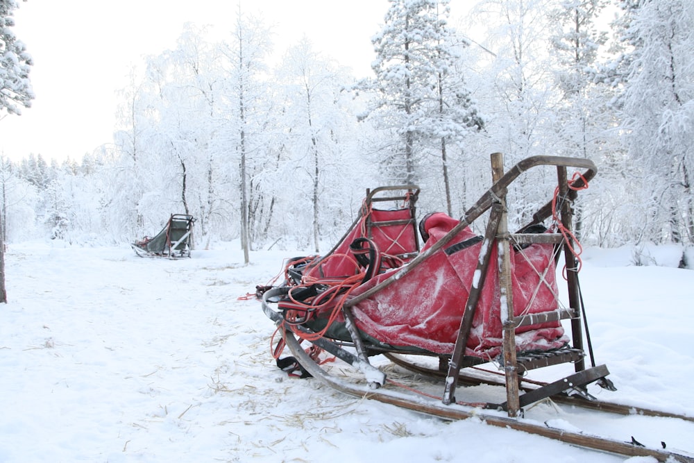 a sled with a red cover on it in the snow