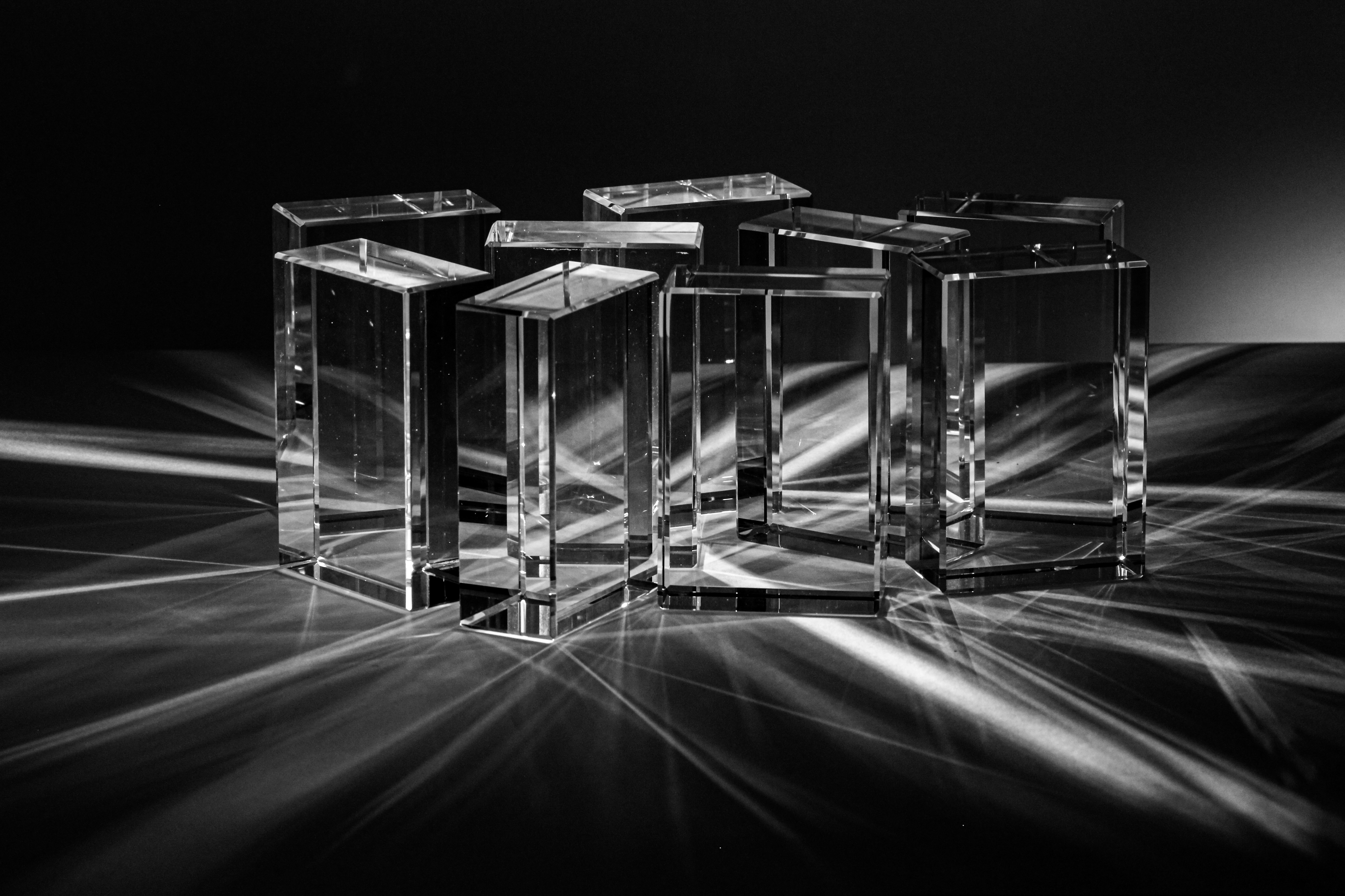 three crystal cubes sitting on top of a table
