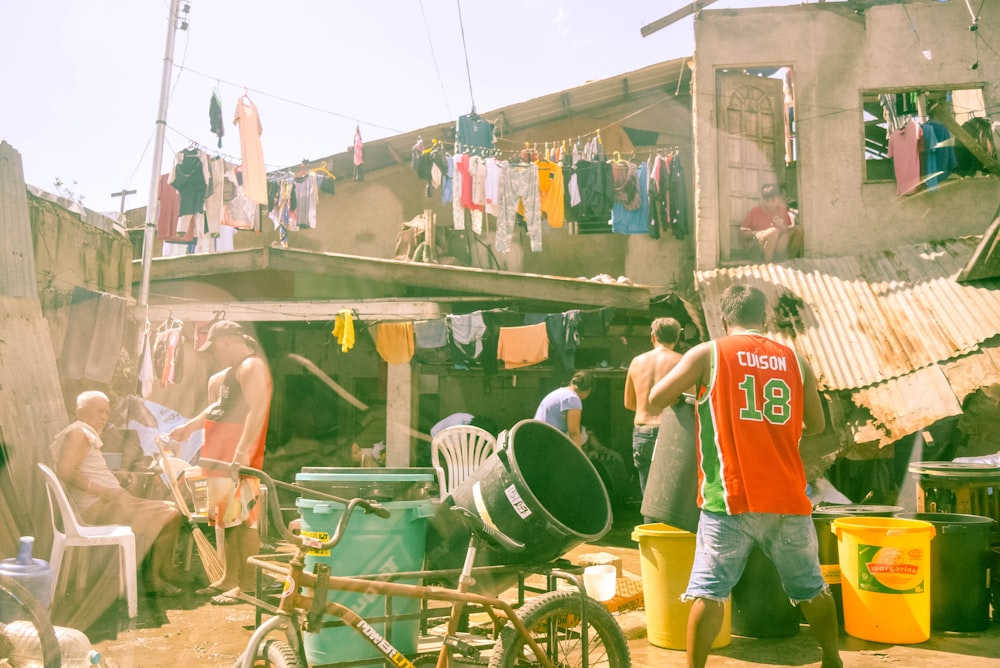 a group of people standing around a shack