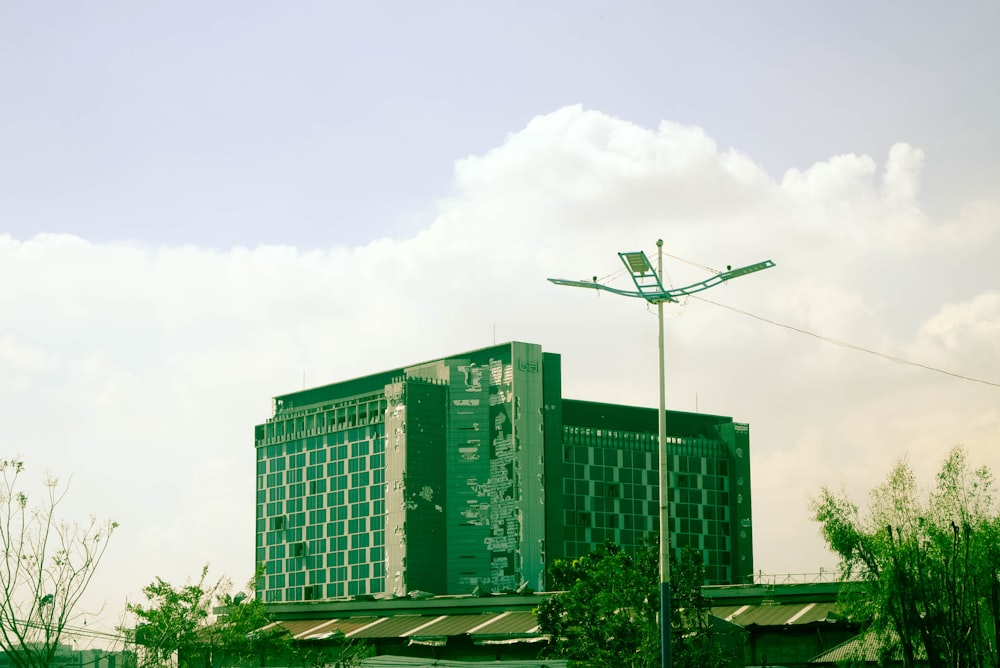 a large green building sitting on the side of a road