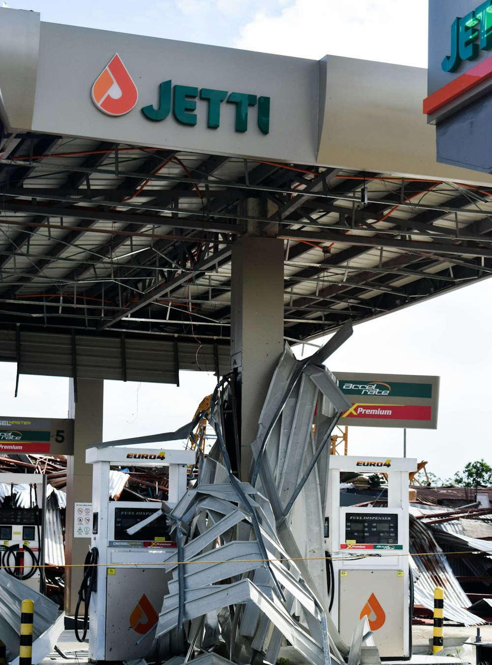 a gas station with a pile of broken metal