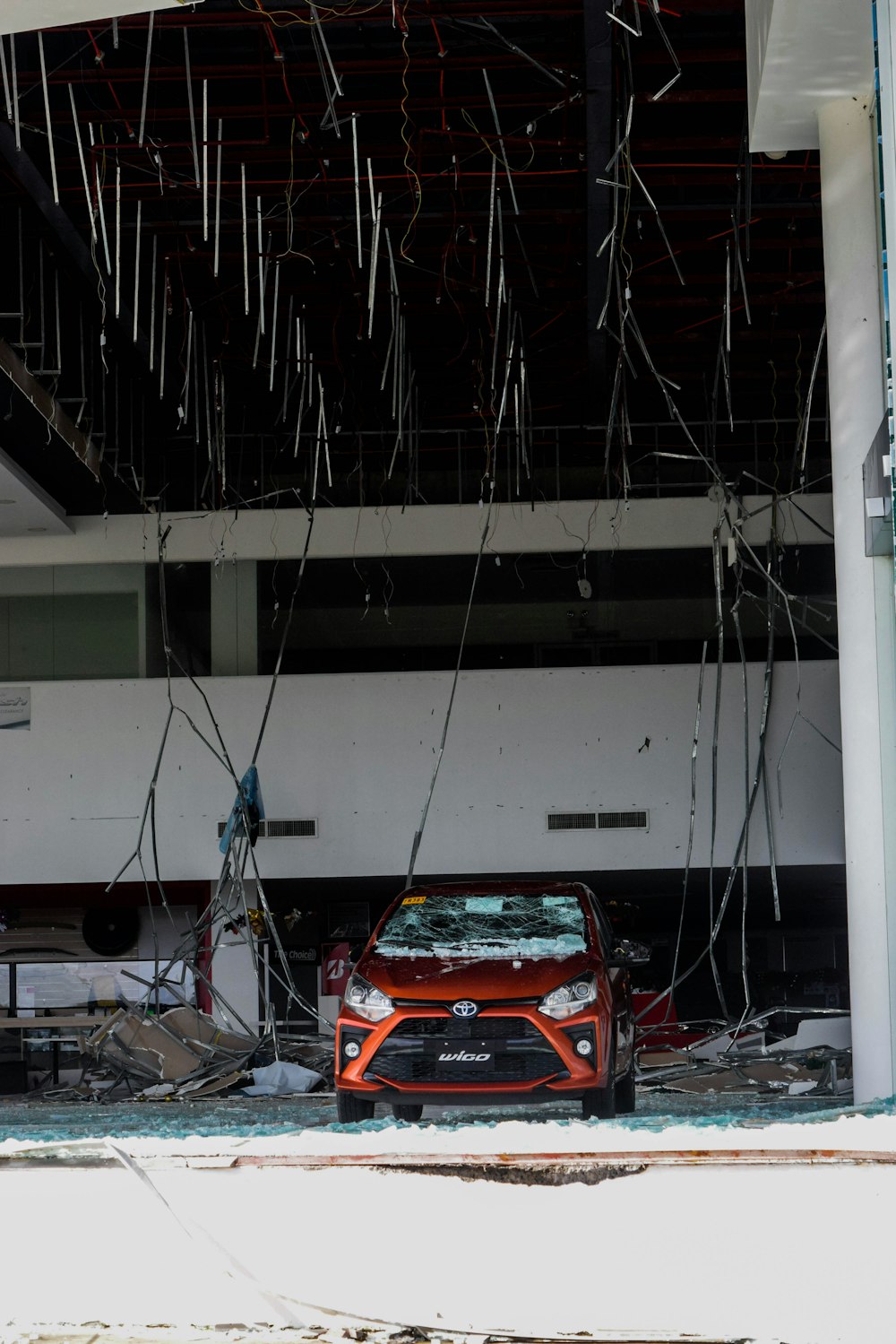 a red car parked in front of a building