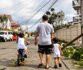 a man and two children walking down a street