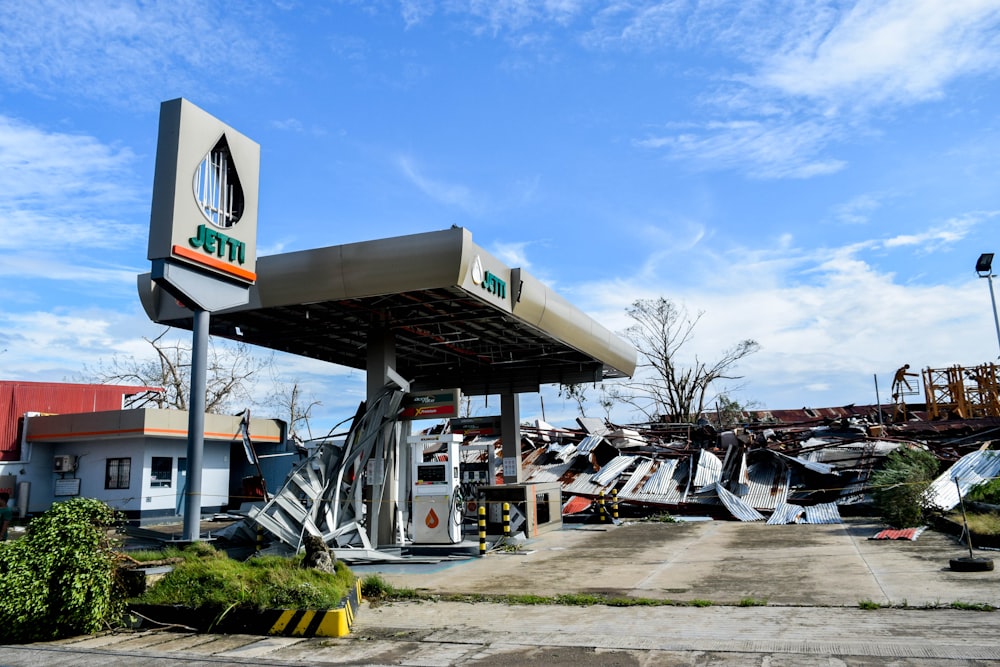 a gas station with a pile of junk in front of it