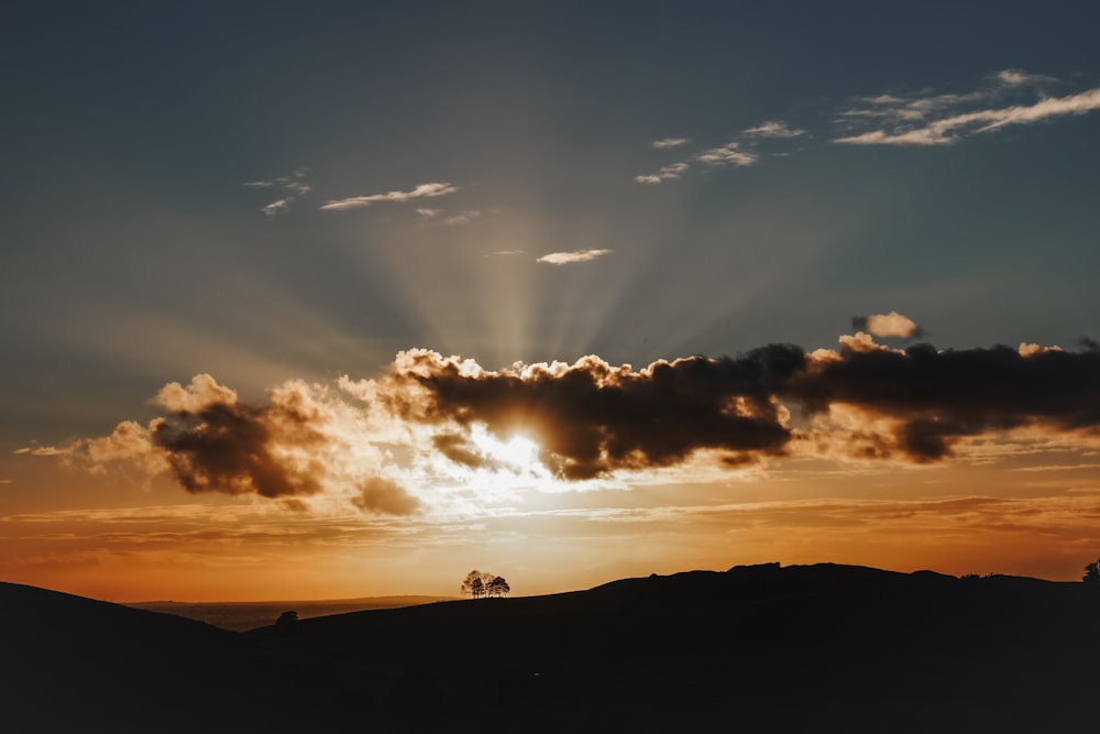 the sun is shining through the clouds in the sky