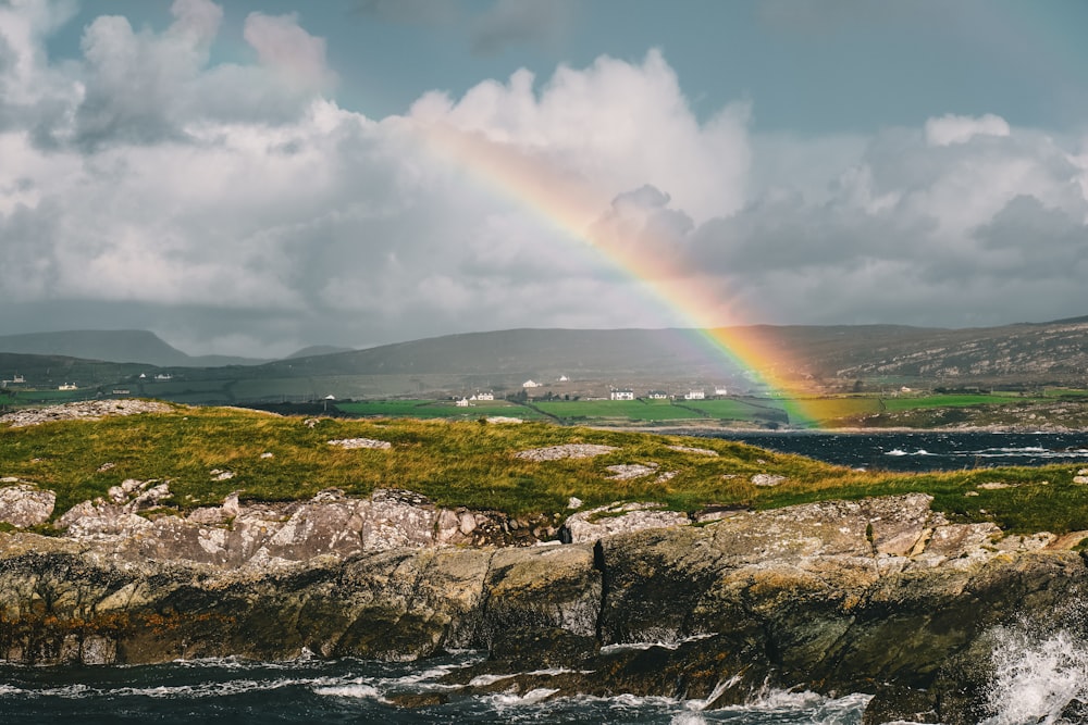 a rainbow in the sky over a body of water