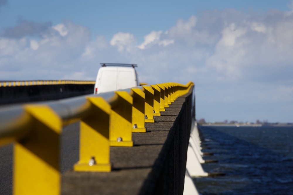 a car driving on a bridge over a body of water