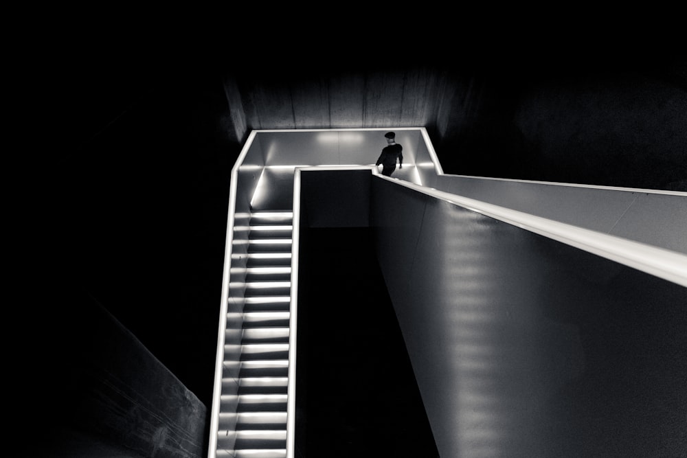 a man is standing on the top of a staircase