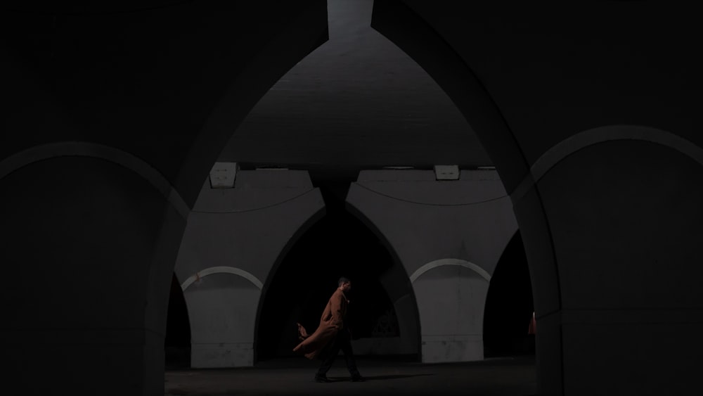 a person walking through a tunnel in the dark