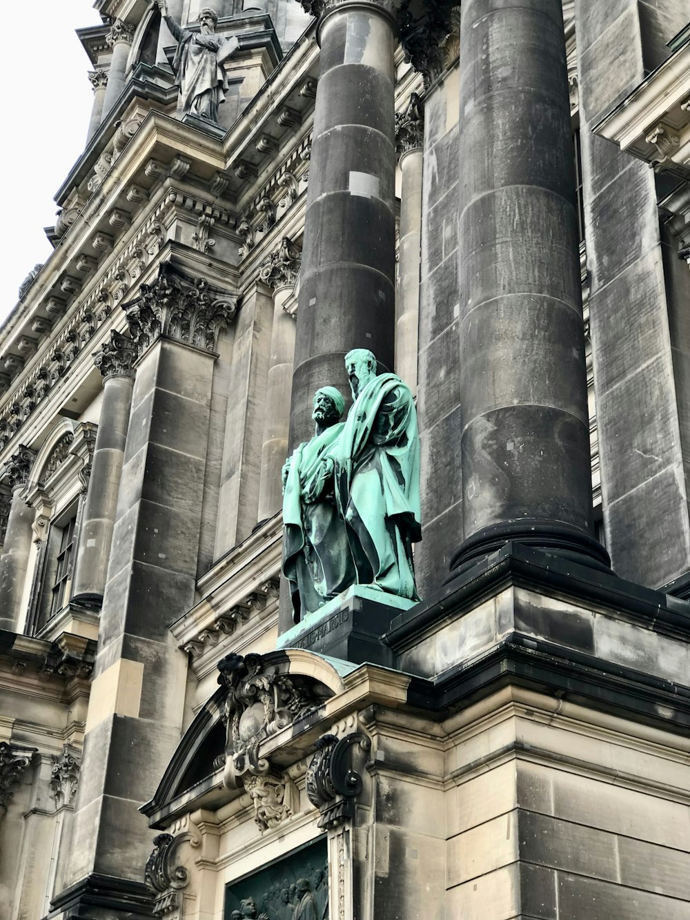 a statue of a man in front of a building