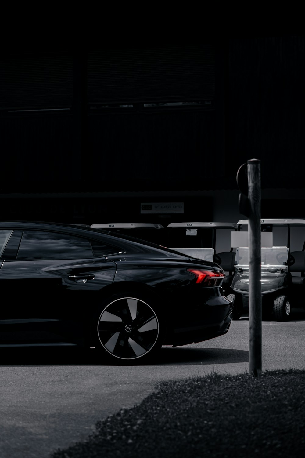 a black car parked in a parking lot at night