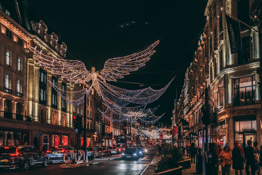 a city street filled with lots of christmas lights,