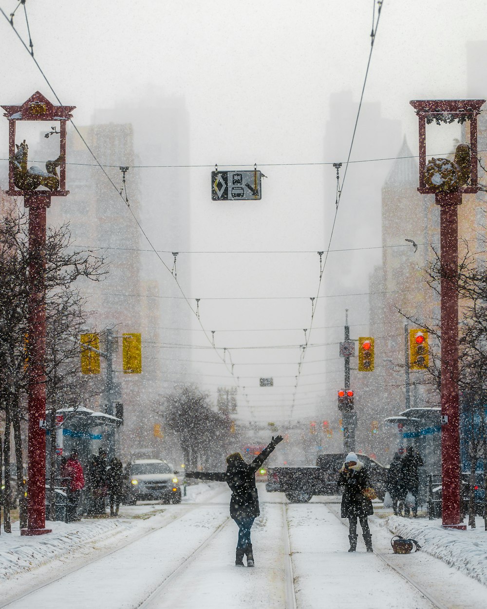 a person skiing down a snow covered sidewalk