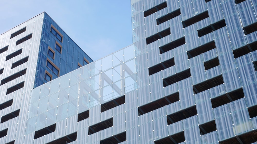 a tall building with lots of windows next to another building