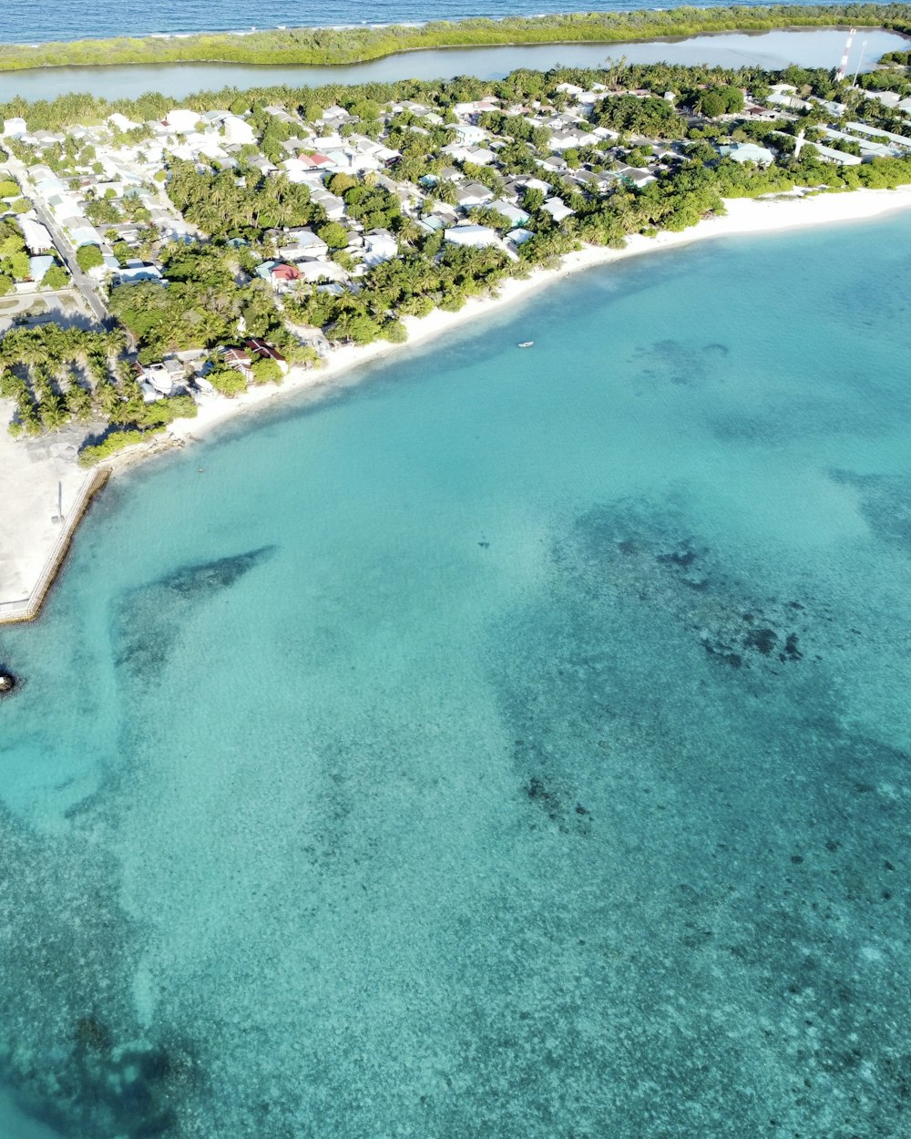 an aerial view of a tropical island with a white sand beach