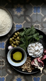 a plate of food on a table with a bowl of olives