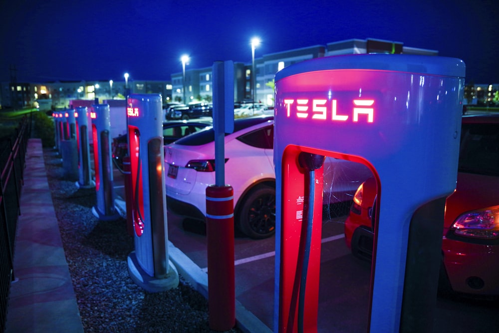 a row of tesla charging stations at night