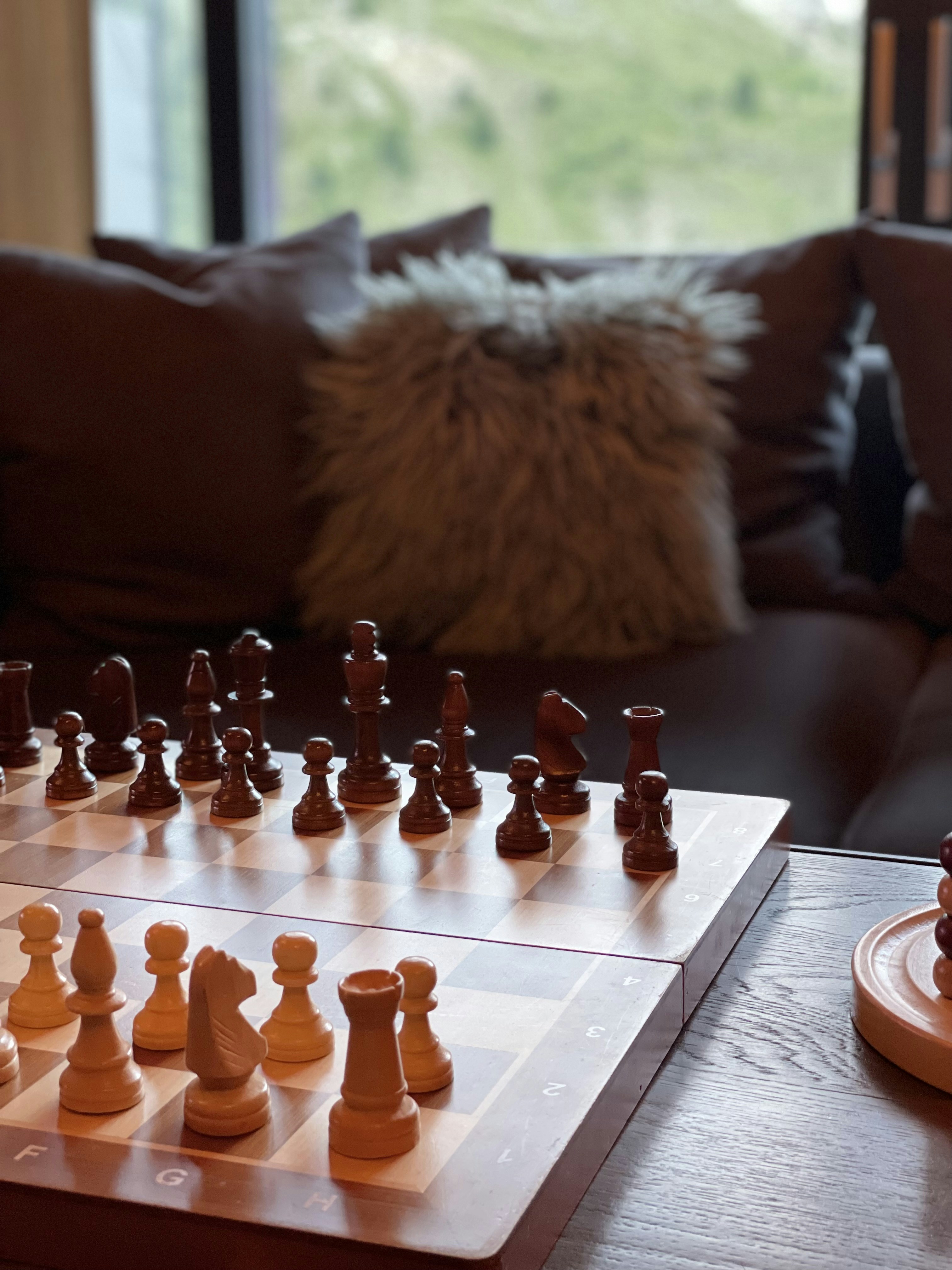 a wooden chess set on a coffee table