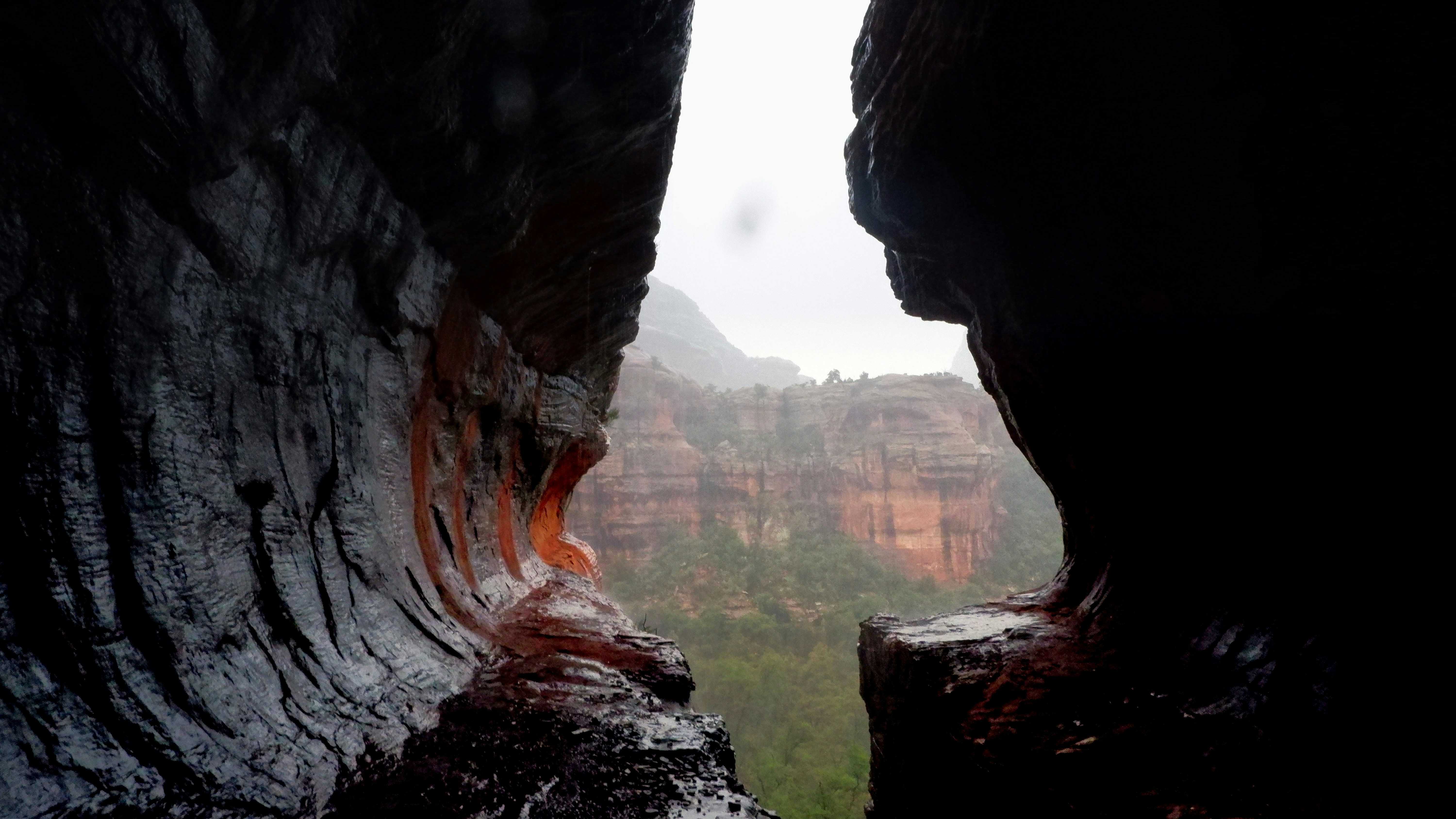 a view of a canyon from inside a cave