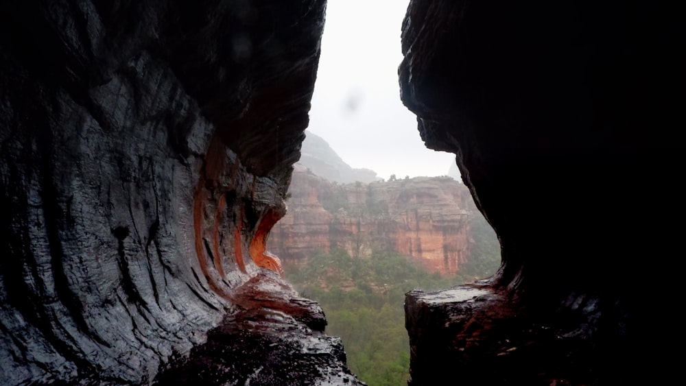 a view of a canyon from inside a cave