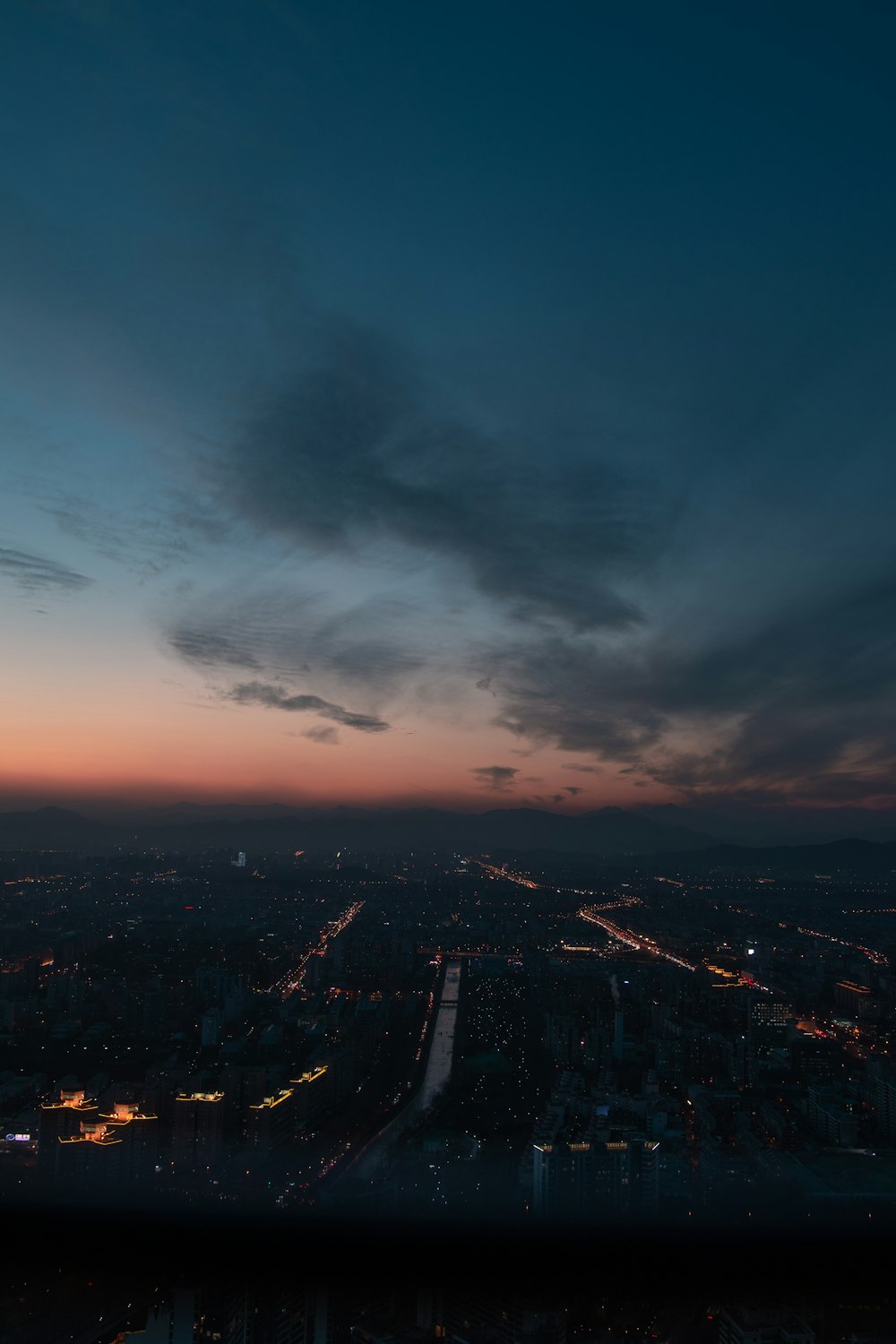 a view of a city at night from the top of a building