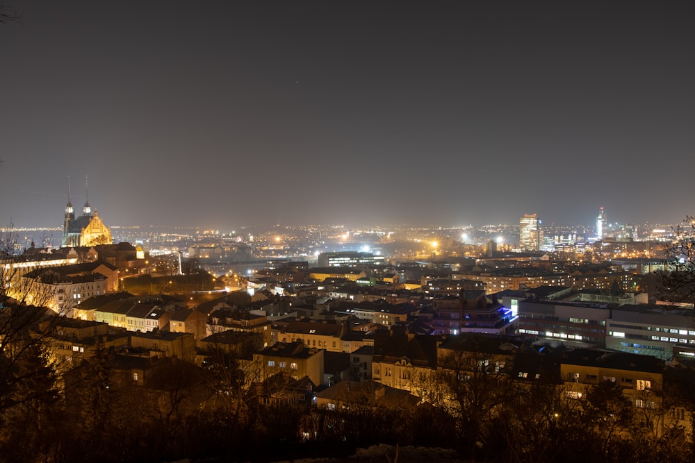 a view of a city at night from a hill