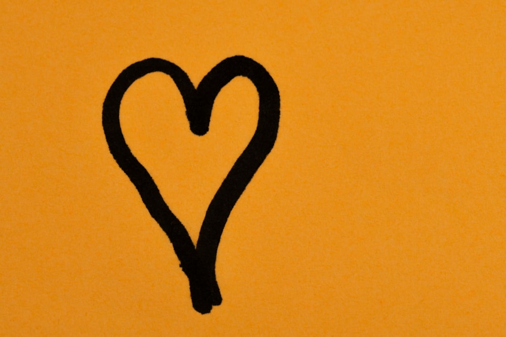 a picture of a heart drawn on a yellow wall