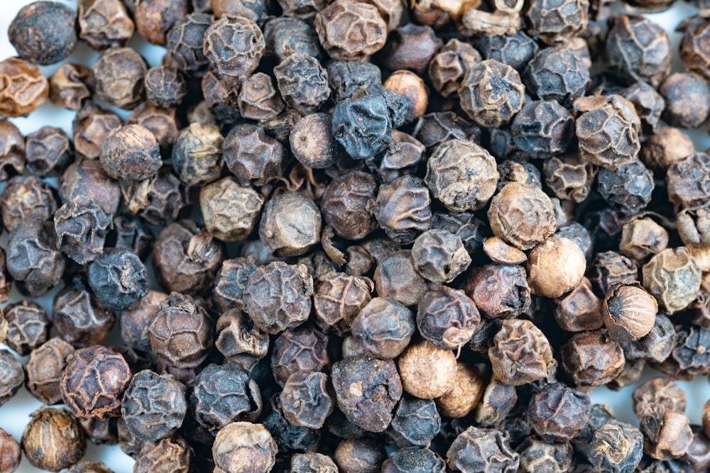 a close up of a pile of black pepper
