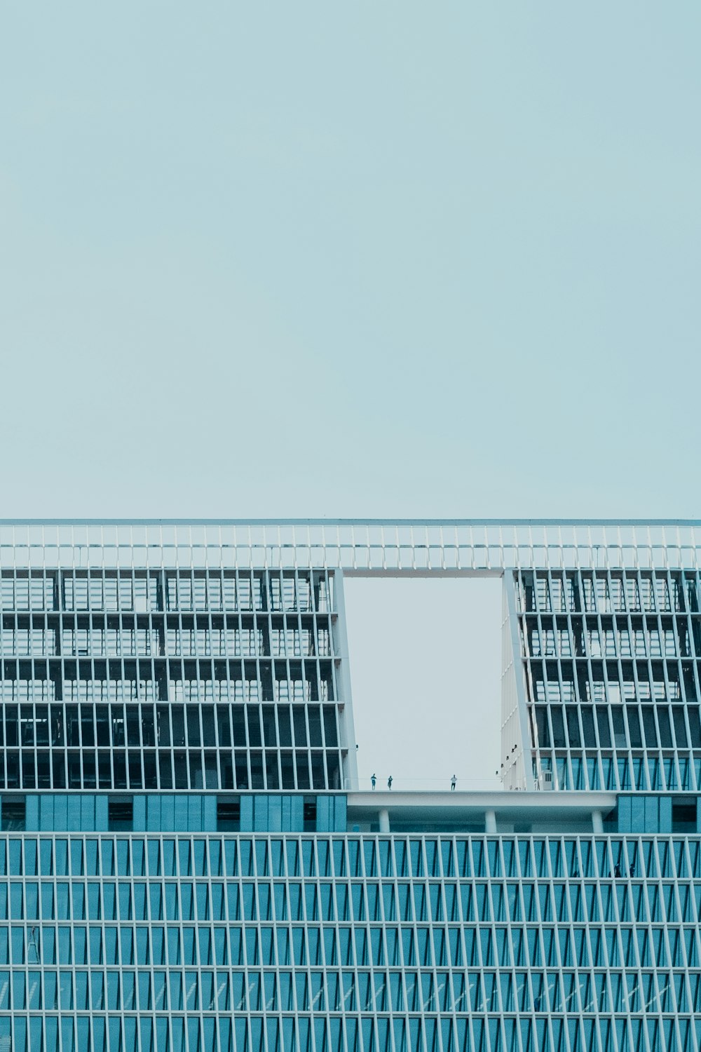 an airplane flying over a building with a sky background