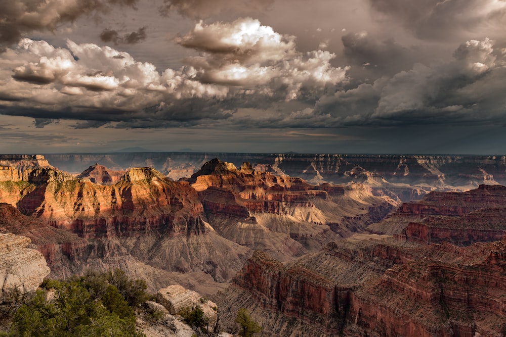 a view of the grand canyon under a cloudy sky