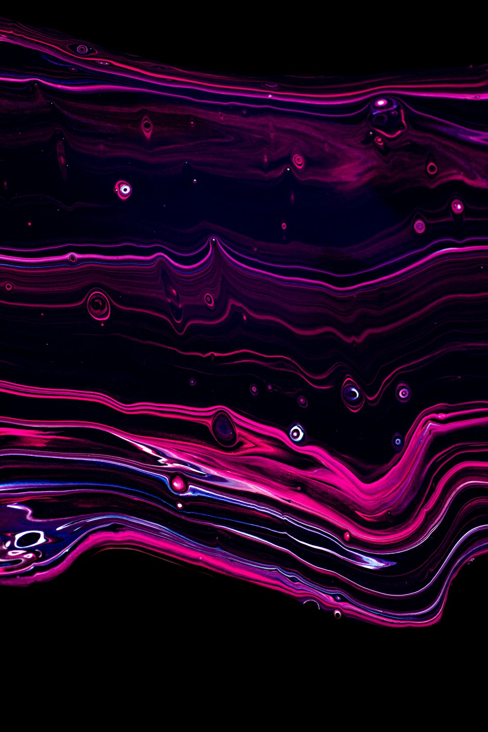 a black background with pink and blue swirls