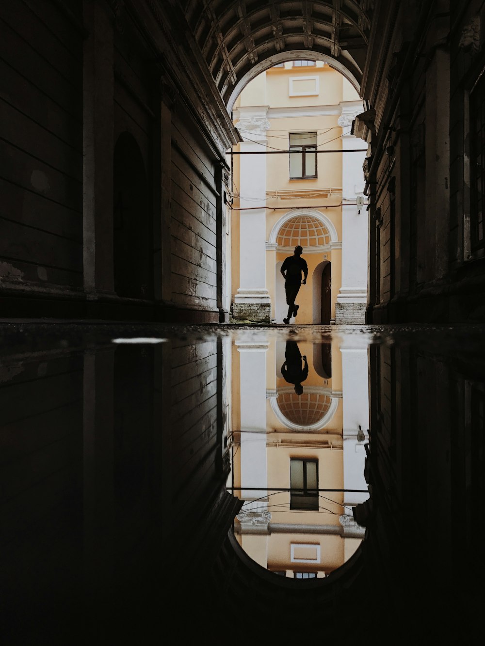 a reflection of a building in a puddle