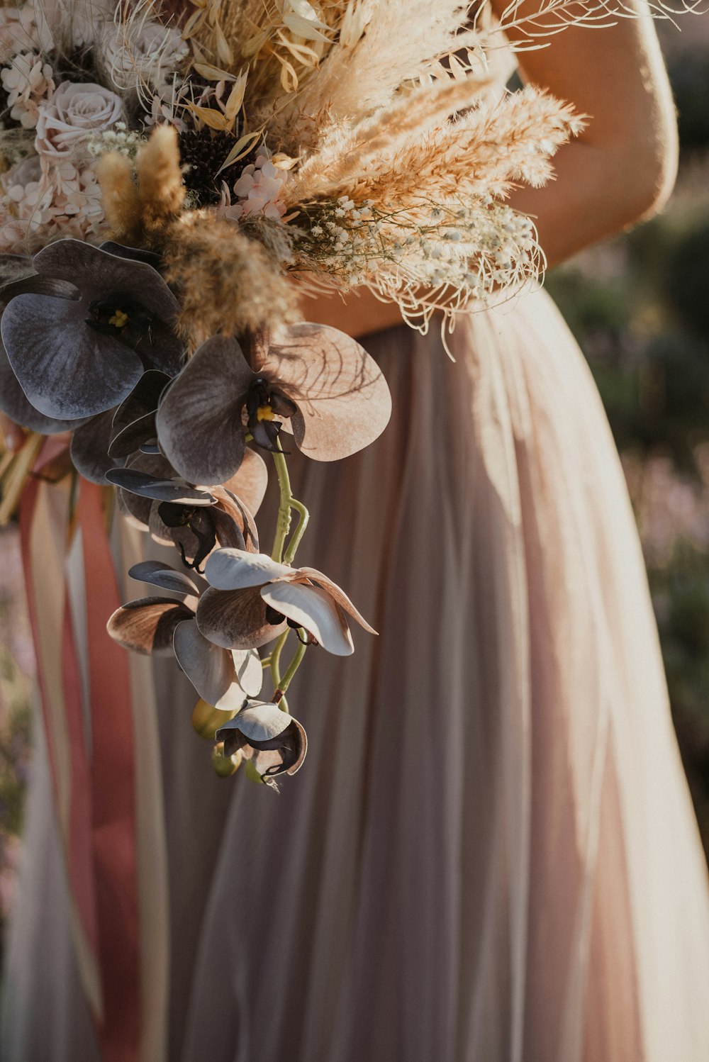 a woman in a dress holding a bouquet of flowers