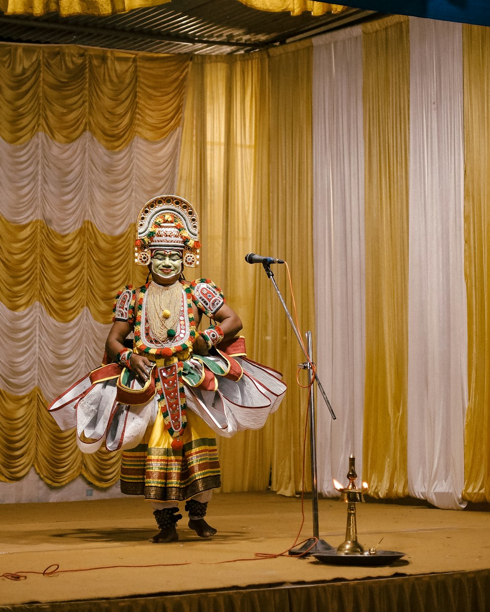 a man standing on a stage in front of a microphone