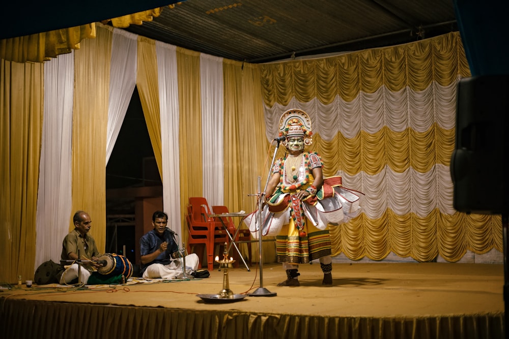 a person standing on a stage with a microphone