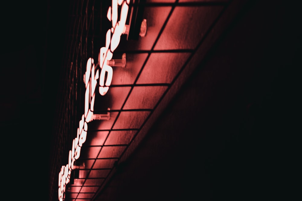 a red neon sign on the side of a building