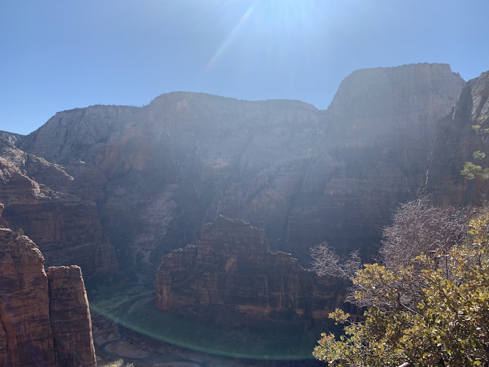 the sun shines brightly over a canyon in the mountains