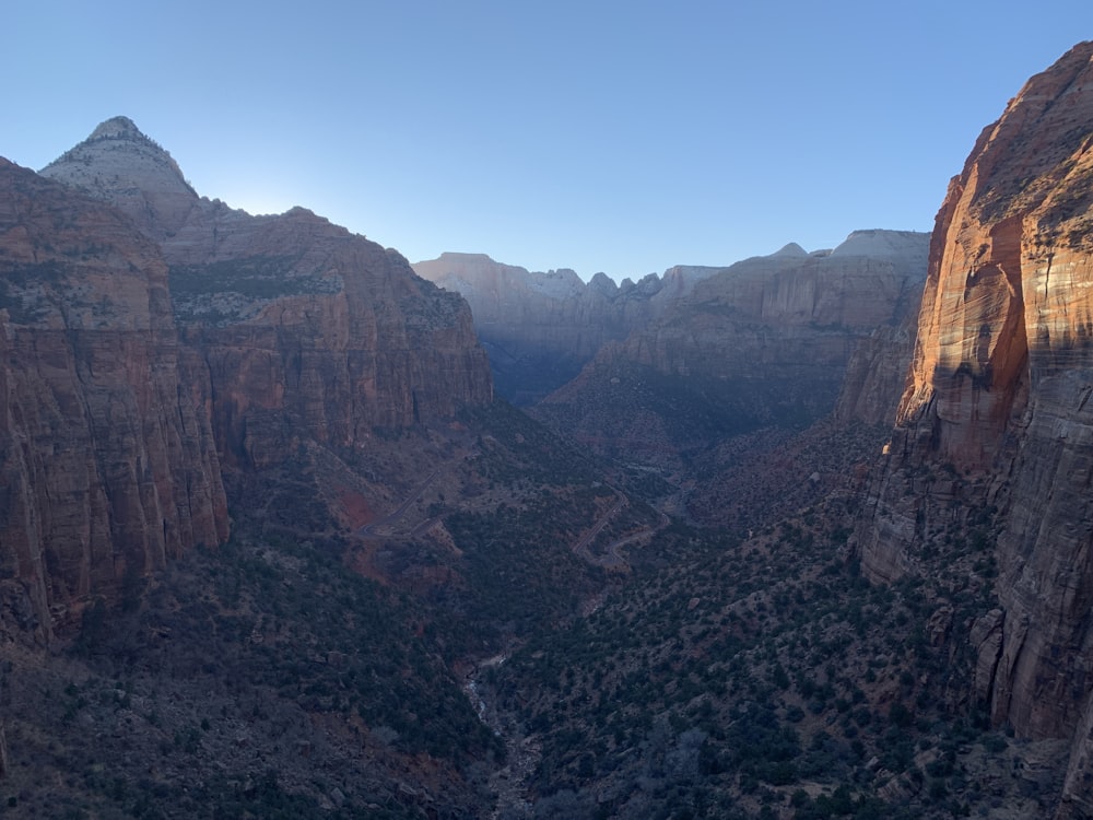 the sun shines on the mountains in the canyon