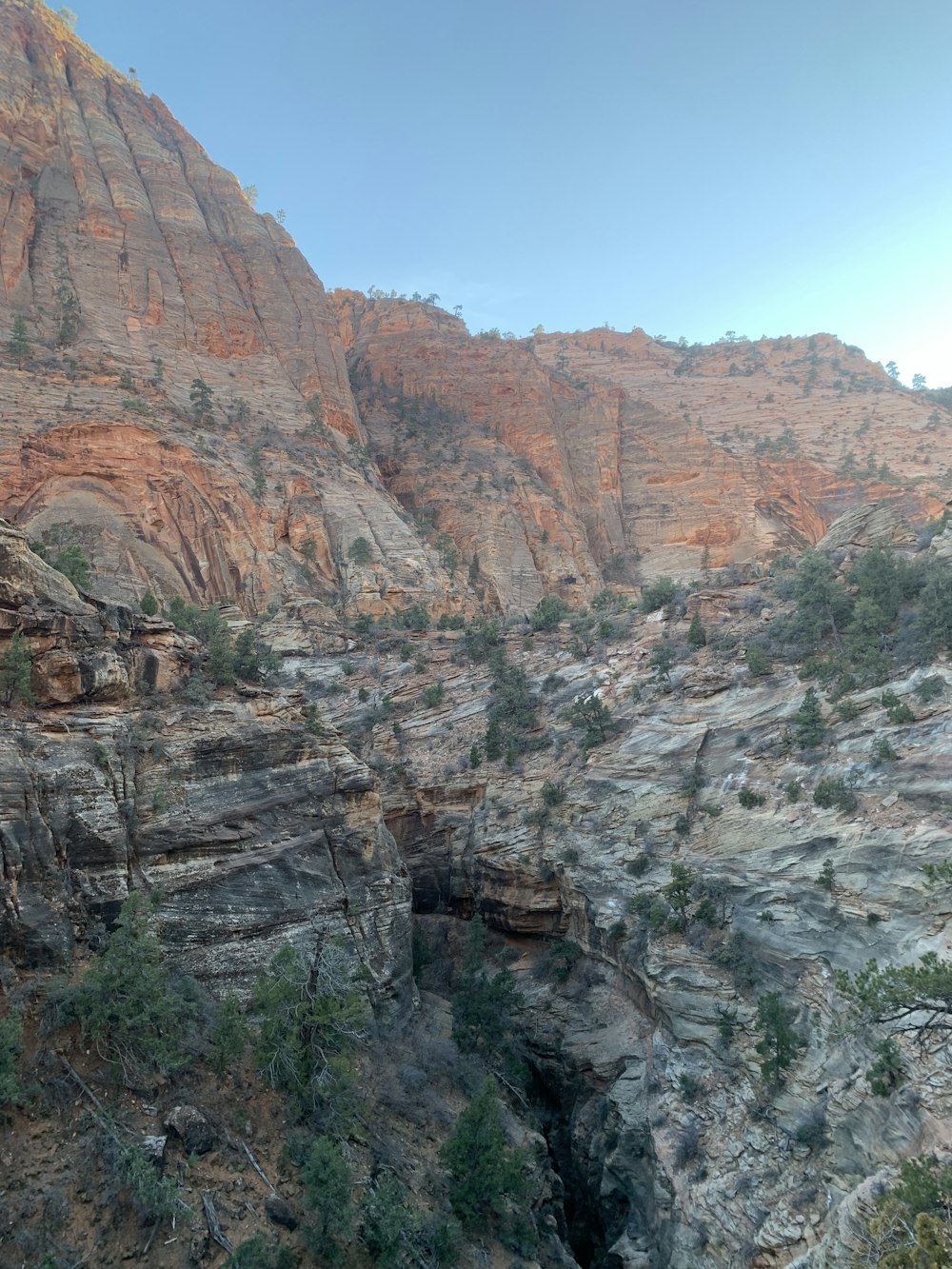 a mountain side with a small cave in the middle of it