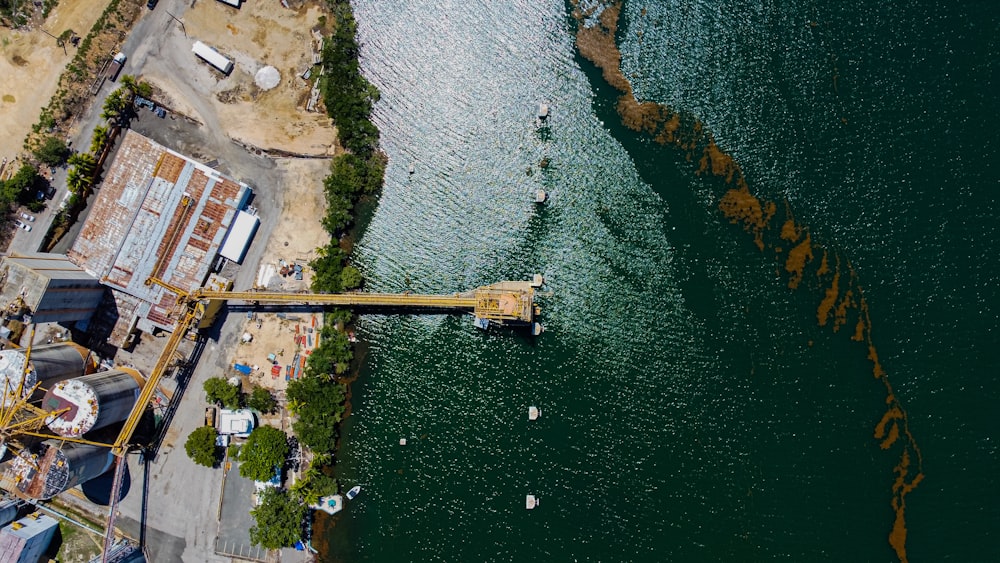 an aerial view of a construction site next to a body of water