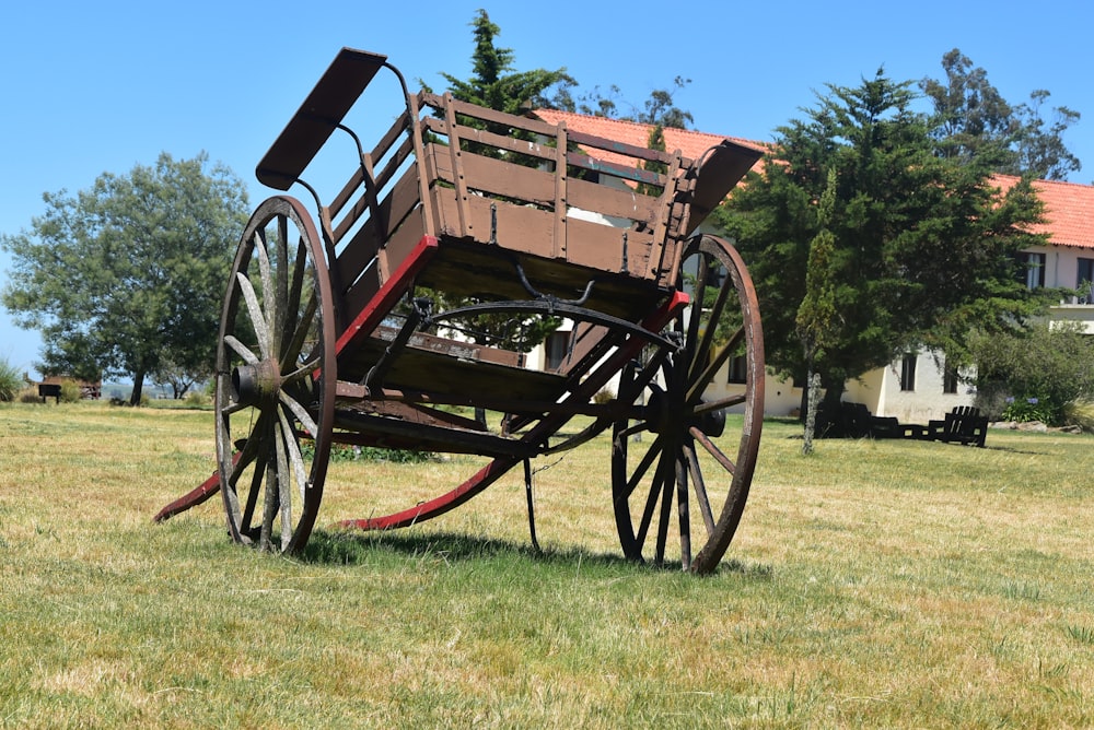 an old wooden wagon sitting in the middle of a field