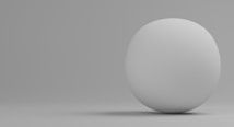 A simple 3D rendering of a smooth, white sphere placed against a neutral gray background. The sphere is positioned slightly to the right with a soft shadow cast on the surface.