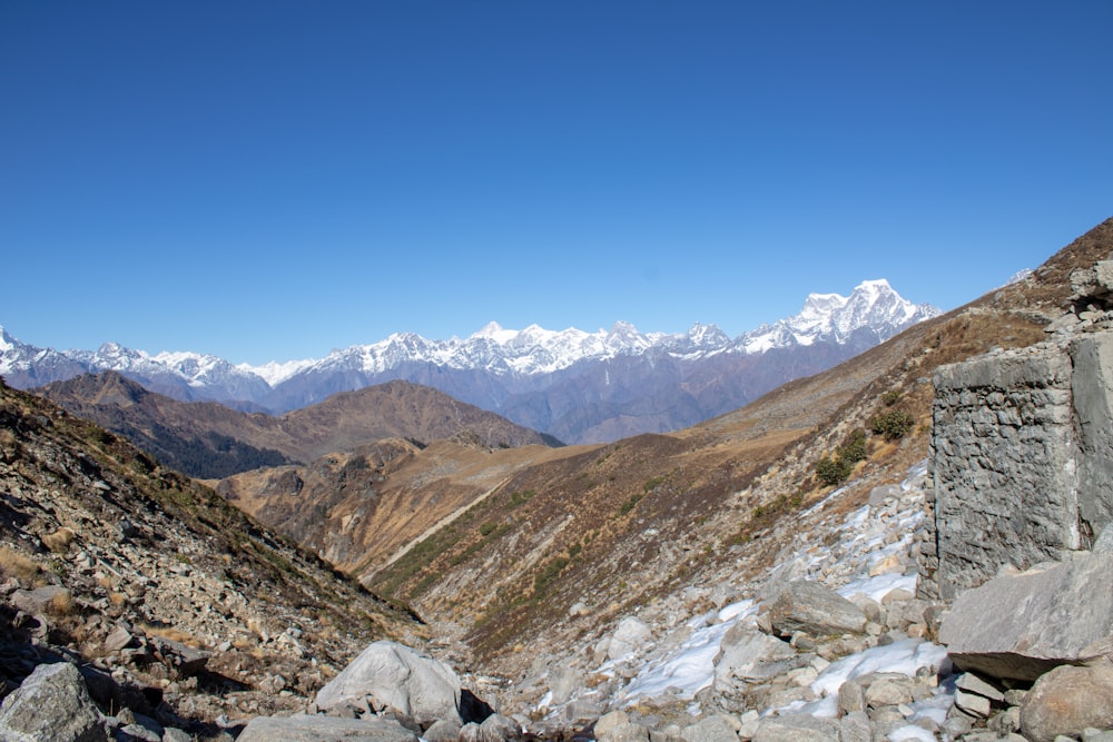 a view of a mountain range with snow capped mountains in the distance