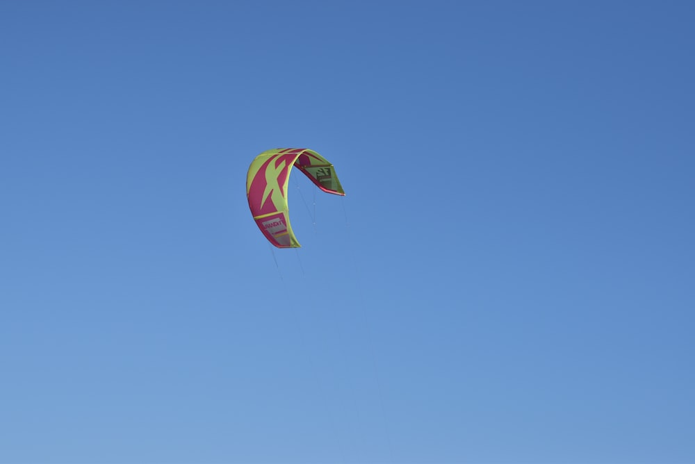 a colorful kite flying in a blue sky