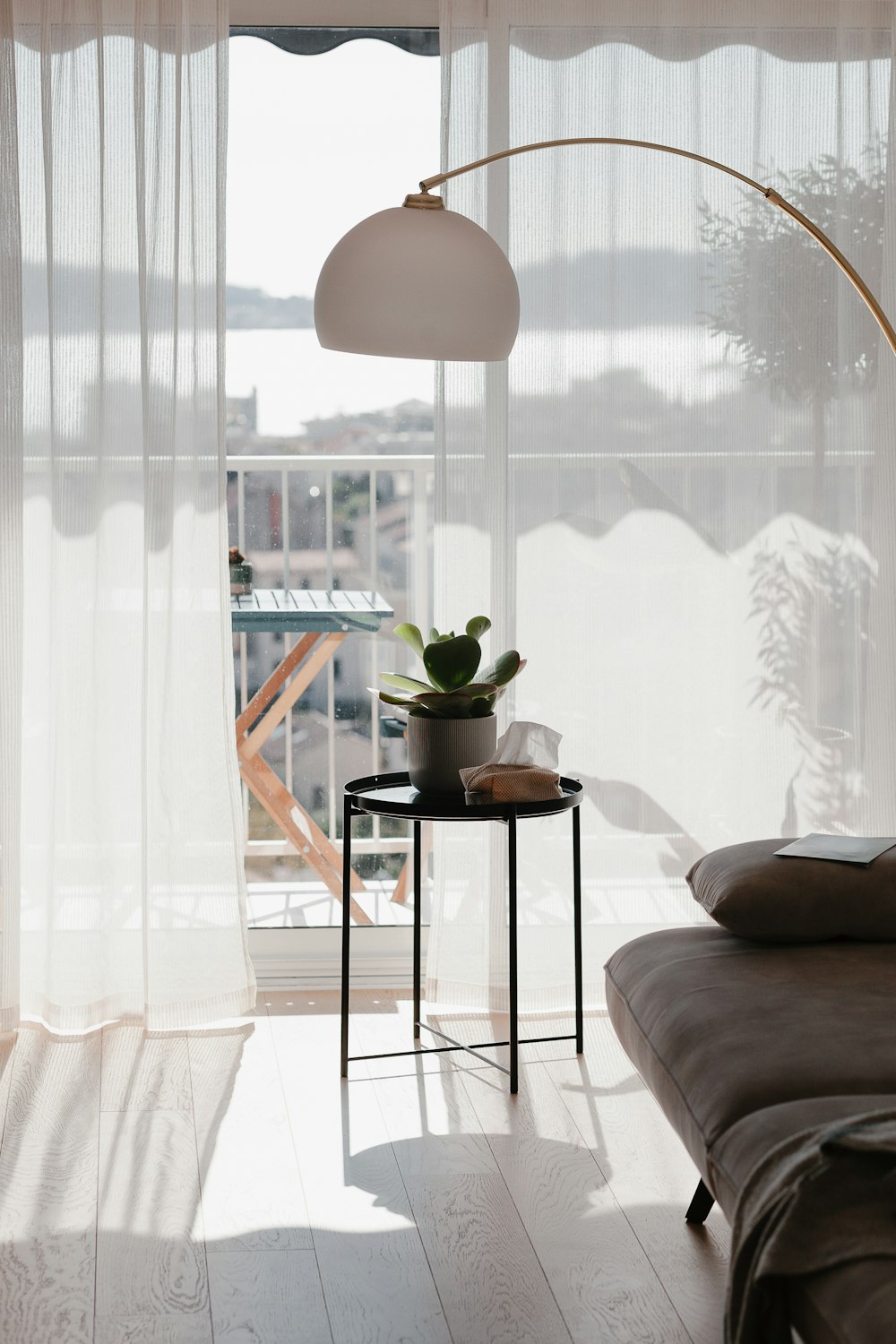 a living room with a couch a table and a lamp