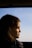 a woman looking out the window of a bus