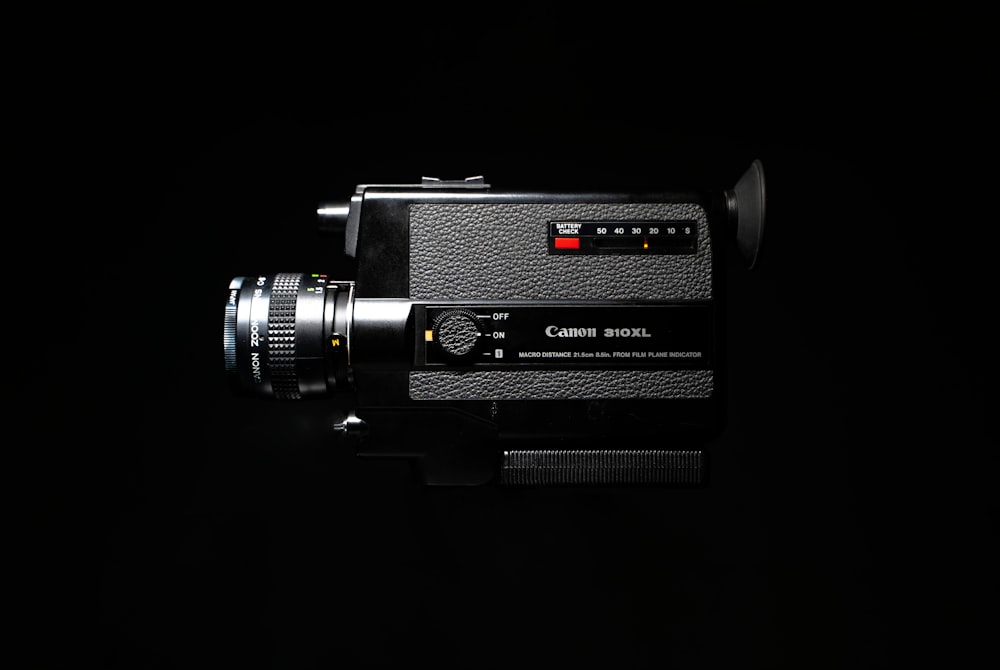 a black camera with a red light on it